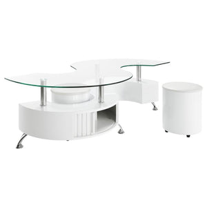 This coffee table features a serpentine shape with a clear tempered glass top and a durable engineered wood base. It includes two stools with padded seats, upholstered in faux leather for added comfort. A sliding door on both sides provides convenient sto