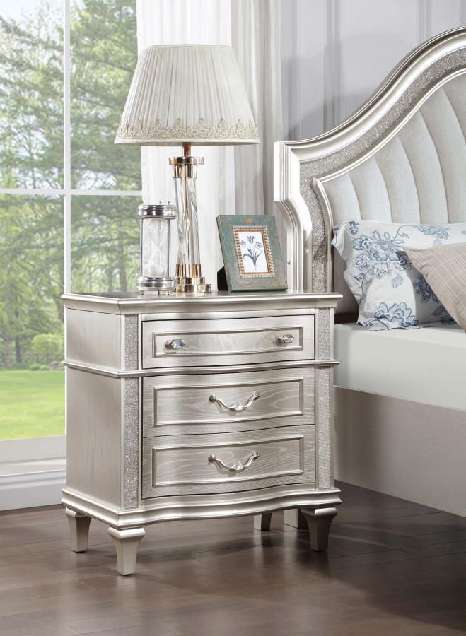 Keep all your bedroom essentials and wardrobe items neatly organized with this glam three-drawer nightstand. A contoured frame design features sparkling side panels flanking the three spacious drawers for a luxurious touch. A silver oak finished wood fram