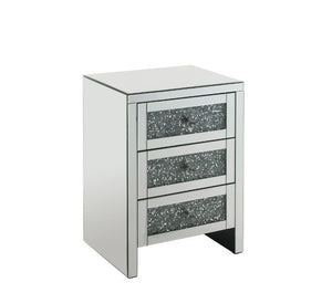 The Noralie Accent Table will give any room a touch of glamour. Mirror and glass materials give it a modern and clear touch while faux diamond inlays add glam style to this piece. Use this unique piece as the perfect accent for any room dÃ©cor. It has thr