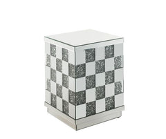 Bring life into your home with this dazzling Noralie End Table. With glamorous mirror finish and faux diamond inlay, the stunning end table will impress all of your guests. The faux diamonds reflect a rainbow of colors throughout the room. The mirrored po
