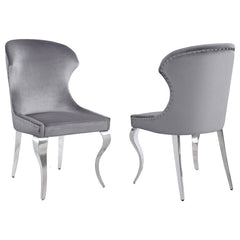 Indulge in the ultimate dining experience with the demi wing dining side chair. Its polished stainless steel cabriole legs exude sophistication, while the individually hand-driven nailhead trim adds a luxurious touch. Wrapped in soft velvet upholstery, th