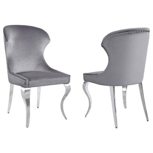 Indulge in the ultimate dining experience with the demi wing dining side chair. Its polished stainless steel cabriole legs exude sophistication, while the individually hand-driven nailhead trim adds a luxurious touch. Wrapped in soft velvet upholstery, th