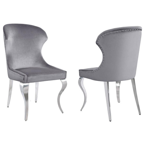 Indulge in the ultimate dining experience with the demi wing dining side chair. Its polished stainless steel cabriole legs exude sophistication, while the individually hand-driven nailhead trim adds a luxurious touch. Wrapped in soft velvet upholstery, th