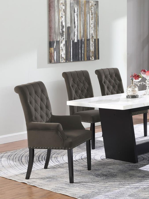  this arm chair brings an elegant presence to any dining space. Its button-tufted high back and rolled top lend a timeless aesthetic