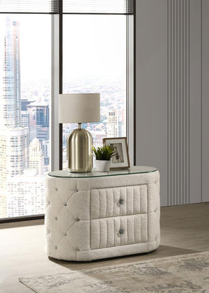 Add a touch of elegance and functionality to your bedroom with this stunning oval nightstand. The plush bouclÃ© upholstery, adorned with sparkling acrylic button tufts, offers both a luxurious feel and eye-catching detail. Two spacious drawers provide amp