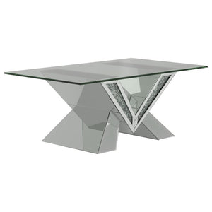 This mirrored coffee table serves as a stunning centerpiece with its bold design. The V-shaped base showcases mirrored panels and sparkling crystal accents for an opulent look. The rectangular, beveled tempered glass top adds elegance and practicality, ma