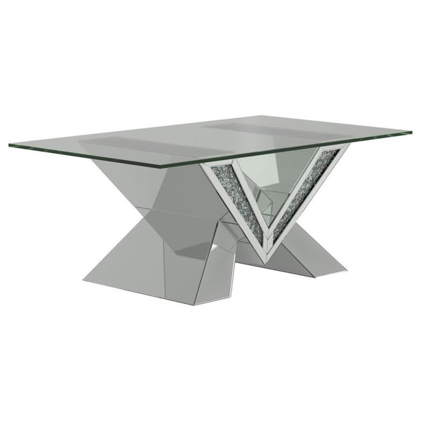 This mirrored coffee table serves as a stunning centerpiece with its bold design. The V-shaped base showcases mirrored panels and sparkling crystal accents for an opulent look. The rectangular, beveled tempered glass top adds elegance and practicality, ma