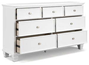  framed drawer fronts and round metal knobs easily adapt to a variety of interiors. Featuring seven storage drawers with dovetail 