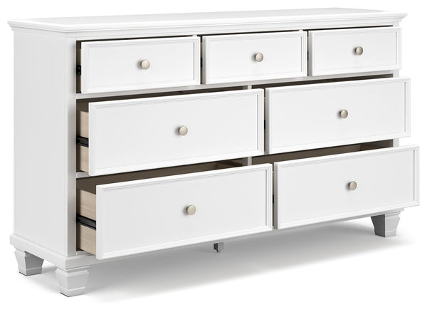  framed drawer fronts and round metal knobs easily adapt to a variety of interiors. Featuring seven storage drawers with dovetail 