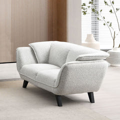 Unwind in the sophisticated charm of the Manon sofa, draped in light gray fabric. Accompanied by plush pillows, it offers a perfect blend of comfort and style. This sofa invites cozy conversations and serene relaxation, making it an ideal addition to any 