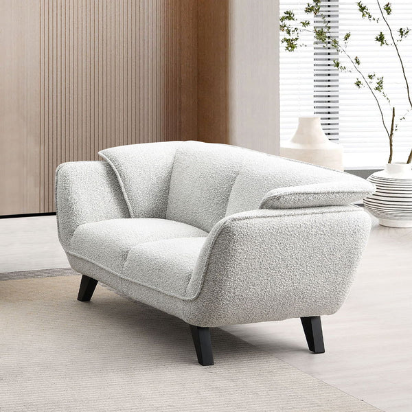 Unwind in the sophisticated charm of the Manon sofa, draped in light gray fabric. Accompanied by plush pillows, it offers a perfect blend of comfort and style. This sofa invites cozy conversations and serene relaxation, making it an ideal addition to any 