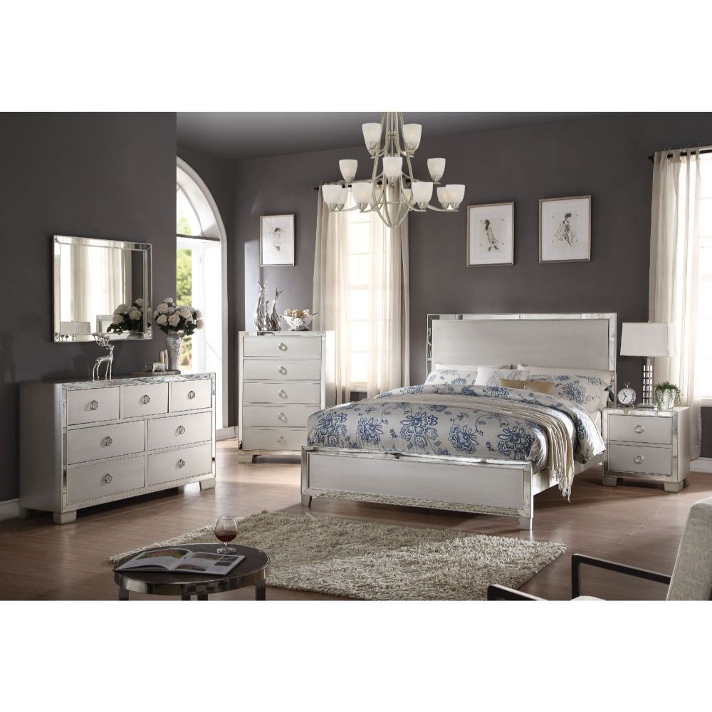 The Voeville II Collection will create a warmer and fresher environment in your master bedroom with its platinum finish. Features panel wooden headboard or upholstered PU headboard for you to choose from, complemented by mirror inlay trim, brings a unique