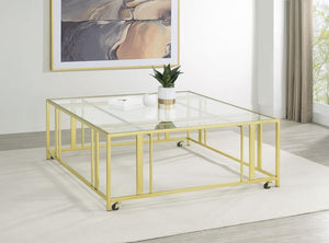  featuring a tempered glass top and a sturdy geometric base made from heavy-gauge metal. The open-frame design creates a sleek