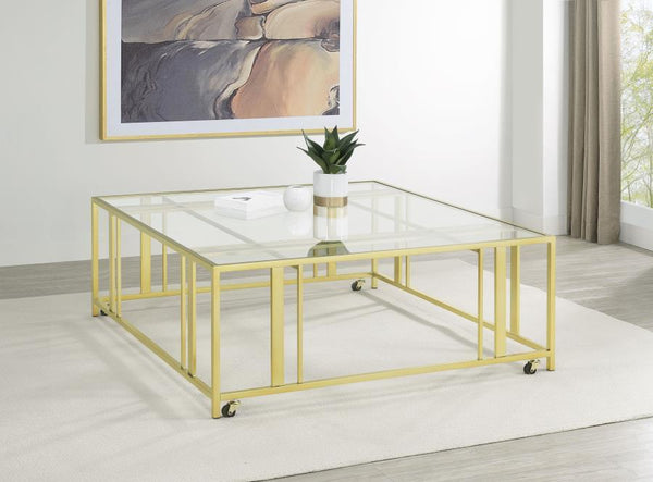  featuring a tempered glass top and a sturdy geometric base made from heavy-gauge metal. The open-frame design creates a sleek