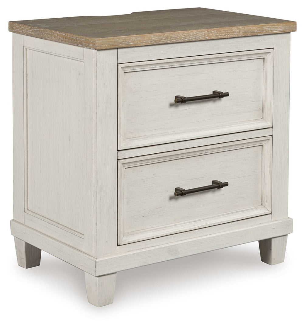This nightstand elevates the art of modern farmhouse design. Its two-tone aesthetic blends antiqued white and light grayish brown for a charming finish. Two strikingly simple drawers lend a hand with conquering clutter, while AC power and two USB ports pr