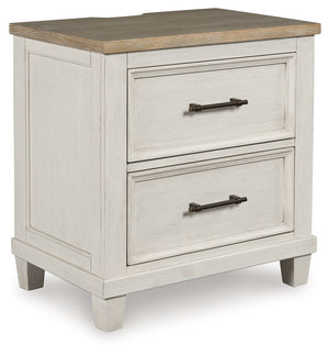 This nightstand elevates the art of modern farmhouse design. Its two-tone aesthetic blends antiqued white and light grayish brown for a charming finish. Two strikingly simple drawers lend a hand with conquering clutter, while AC power and two USB ports pr