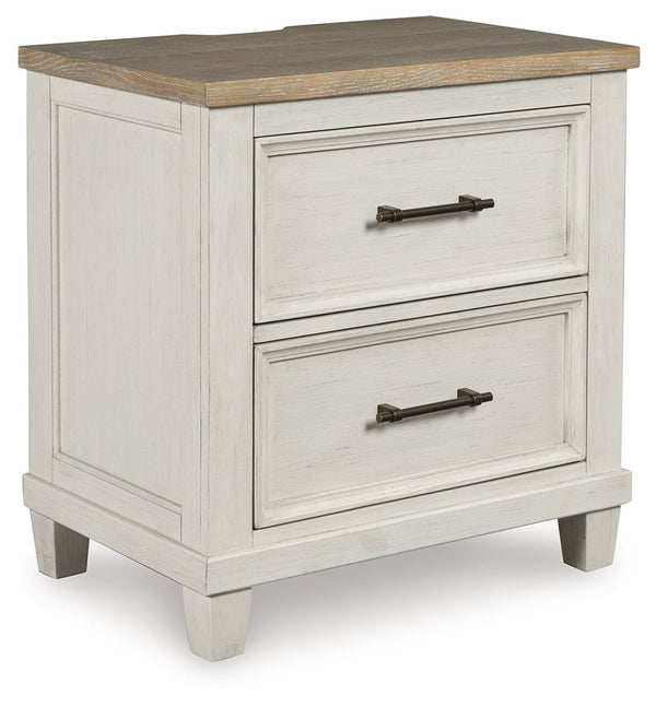 This nightstand elevates the art of modern farmhouse design. Its two-tone aesthetic blends antiqued white and light grayish brown for a charming finish. Two strikingly simple drawers lend a hand with conquering clutter, while AC power and two USB ports pr