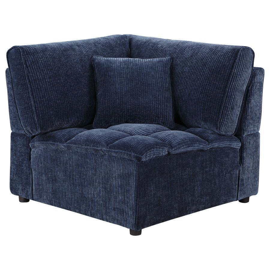 The corner chair seamlessly connects sectional components while maintaining style and comfort. Upholstered in soft blue corduroy with a pillow top grid-tufted design, it provides deep, supportive seating. The fully encased solid and engineered wood frame,