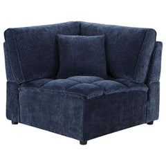 The corner chair seamlessly connects sectional components while maintaining style and comfort. Upholstered in soft blue corduroy with a pillow top grid-tufted design, it provides deep, supportive seating. The fully encased solid and engineered wood frame,