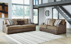Punctuated by a subtle band of nailhead trim, this sofa & loveseat are perfect for those who love the look of leather. Two textural tones provide twice the style and comfortâ€”and incorporate an added layer of visual interest. Throw pillows add a fun deco
