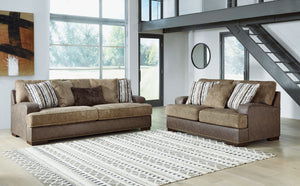 Punctuated by a subtle band of nailhead trim, this sofa & loveseat are perfect for those who love the look of leather. Two textural tones provide twice the style and comfortâ€”and incorporate an added layer of visual interest. Throw pillows add a fun deco