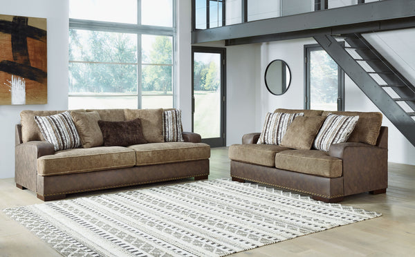 Punctuated by a subtle band of nailhead trim, this sofa & loveseat are perfect for those who love the look of leather. Two textural tones provide twice the style and comfortâ€”and incorporate an added layer of visual interest. Throw pillows add a fun deco