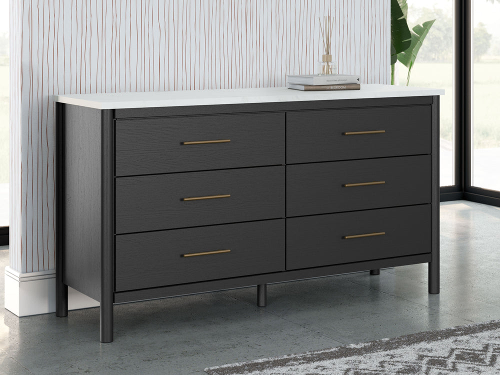 This dresser reflects your sophisticated approach to boho style. Crafted with both form and function in mind, its replicated marble top beautifully contrasts a matte black finish. The versatile design suits all-neutral spaces or blends with your favorite 