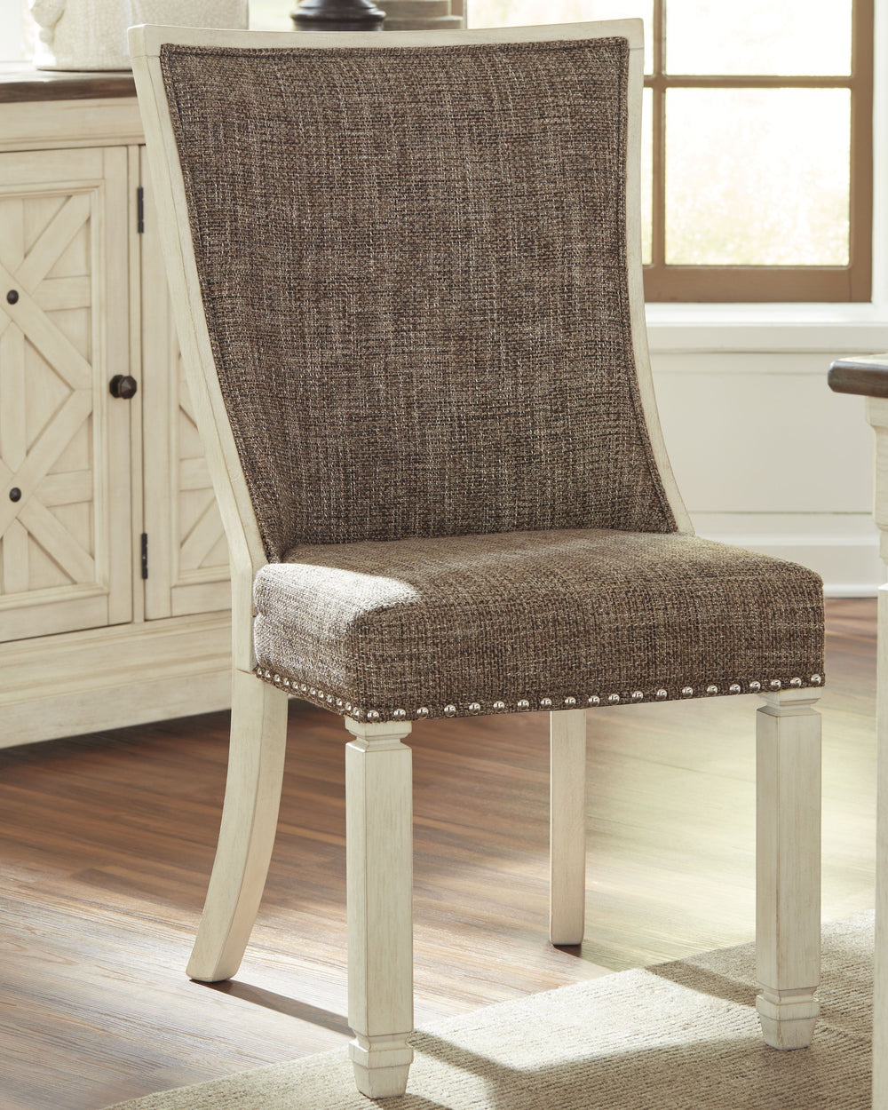 The beauty of this upholstered dining chair is something to savor. Contoured seat cradles you in cushioned comfort while lattice peekaboo detail on the back makes this a striking chair from all angles. Heavy woven fabric adds textural interest that comple