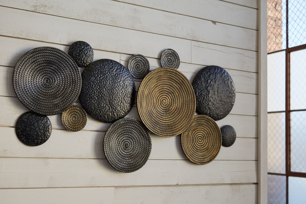 Round out your contemporary space with this forward-thinking wall sculpture. Circles in varying textures and sizes are simply striking when paired together, adding a modern twist to classic geometric construction. Complete with assorted metallic finishes,