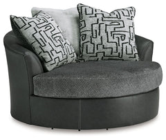 Appeal to your eye for ultra-contemporary design with this oversized swivel chair. Chic and sleek in dark neutrals, it pairs cozy fabric with faux leather for invitingly cool character. And with its robust size offering extra seating space, you can chill 