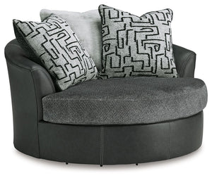 Appeal to your eye for ultra-contemporary design with this oversized swivel chair. Chic and sleek in dark neutrals, it pairs cozy fabric with faux leather for invitingly cool character. And with its robust size offering extra seating space, you can chill 