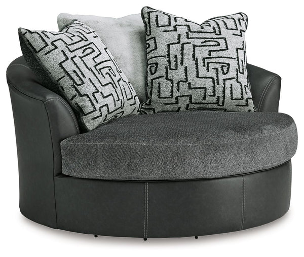 Appeal to your eye for ultra-contemporary design with this oversized swivel chair. Chic and sleek in dark neutrals, it pairs cozy fabric with faux leather for invitingly cool character. And with its robust size offering extra seating space, you can chill 