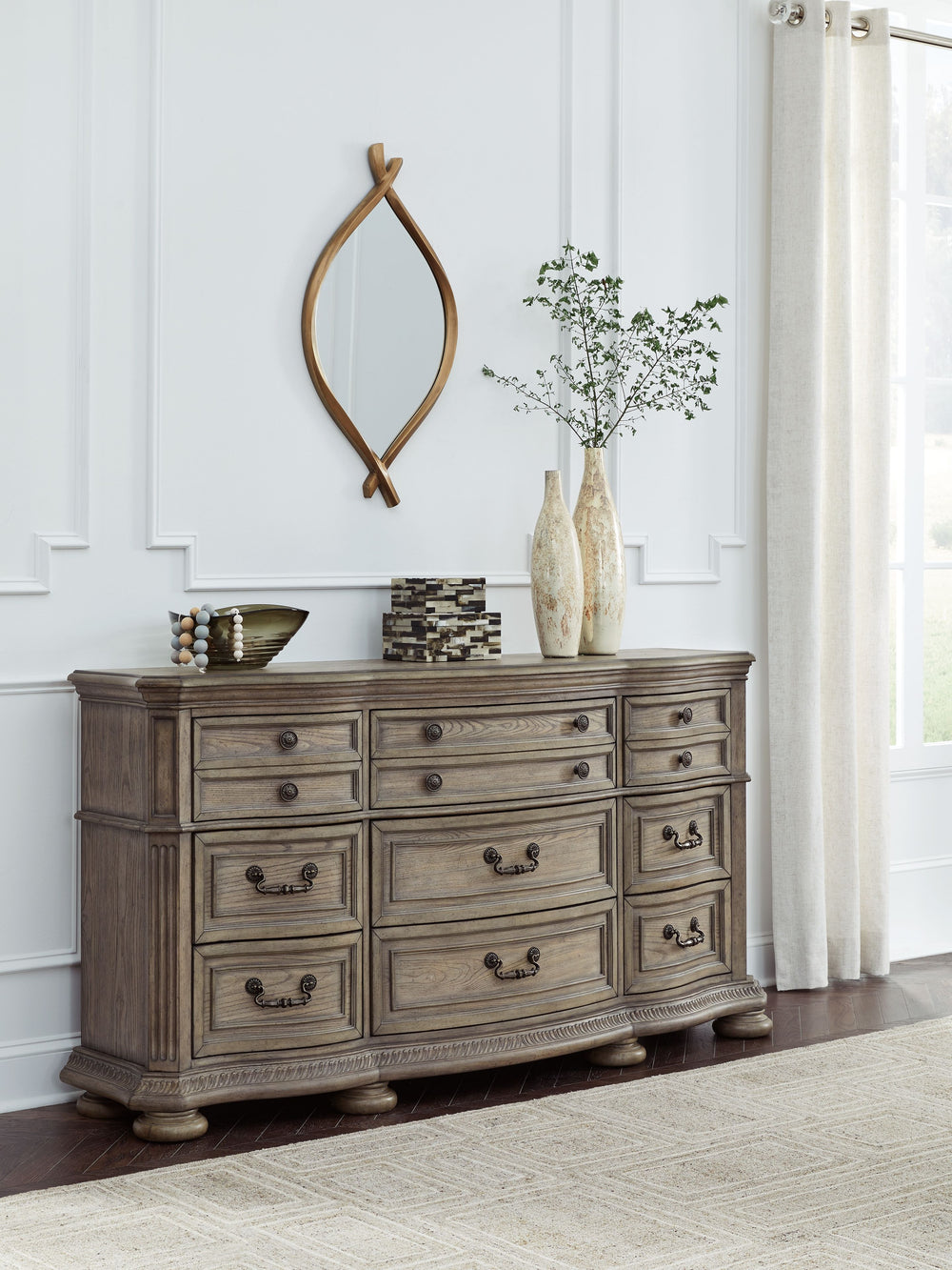 Merging traditional elegance with modern comfort, this dresser takes your bedroom retreat to the next level. Serpentine curves, ash swirl veneer inlays and a glazed antiqued-look finish radiate timeless sophistication. Drawers of various sizes are packed 
