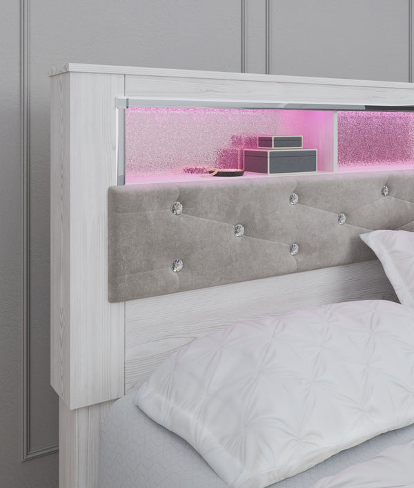 a pearlized finish and button-tufted upholstery bring a glam touch to the richly rustic appearance. Remo