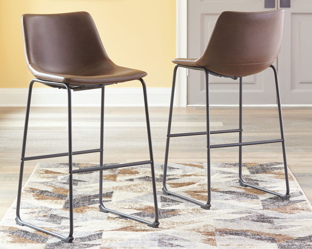 With its distinctive contoured bucket seat and tubular metal base, this bar stool serves up a fresh twist on mid-century inspired style. Faux leather upholstery has a charming medium brown tone. What a timeless look for eat-in kitchens and casually cool d