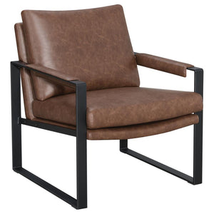 Add an industrial-chic touch to your living space with this accent chair wrapped in warm umber brown leatherette. Designed with a sleek gunmetal metal frame and padded armrests, it balances retro vibes with modern comfort. Reversible cushions and a suppor
