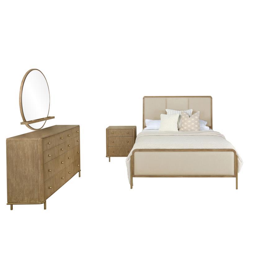 This coastal-inspired bedroom set blends mid-century modern influences with natural textures for a serene retreat. The bed features a cream fabric upholstered headboard and footboard, framed by a wire-brushed wood finish that enhances the beauty of rubber