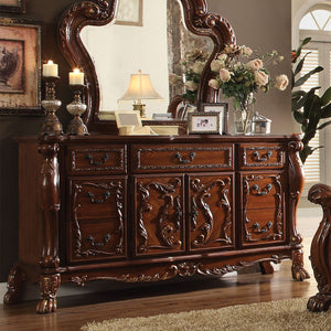 The Dresden Dresser/Server is crafted with the finest solid woods with veneers in cherry oak finish. Dresden Collection is enhanced by remarkable marquetry and generously carved wood elements. The case goods feature solid hardwood with five drawers and tw