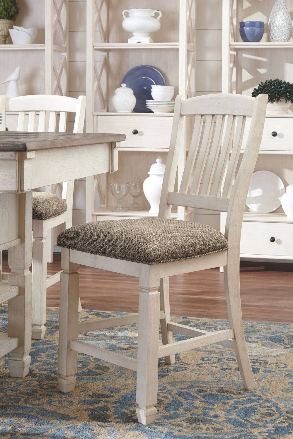 Unique two-tone finish with a combination of Oak and Acacia substrates combining a trendy textured antique white color with table and server tops finished in a textural weathered oak finish. Rectangular dining table features six convenient drawers for sto