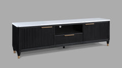 This entertainment console brings modern luxury and sleek sophistication to any living space. Featuring a striking contrast of a black, fluted wood facade with a pristine white faux marble top, this piece embodies refined elegance. Brass-tone accents and 