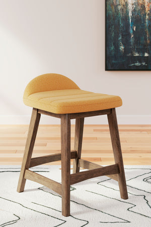  capturing the architectural language of mid-century stylings. The seat invites the eye with a soft-edged silhouette and mustard yellow cushion. A