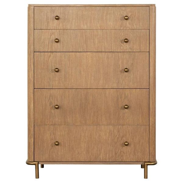  five-drawer chest offers a gorgeous contemporary glam look with its softly rounded corners and aged brass metal hardware. A neutral sand wash wood tone with a wire-brushed finish adds texture and warmth to bedrooms. Clev