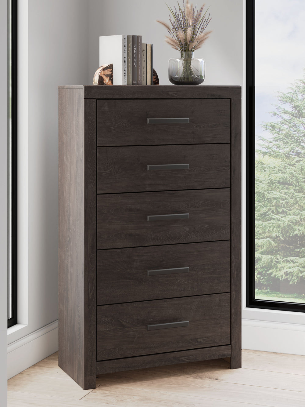 Designed with everyday style in mind, this chest of drawers is a simply chic approach to modern living. A dark charcoal finish blends black and brown undertones, creating a versatile look that effortlessly pairs with your existing pieces. And for must-hav