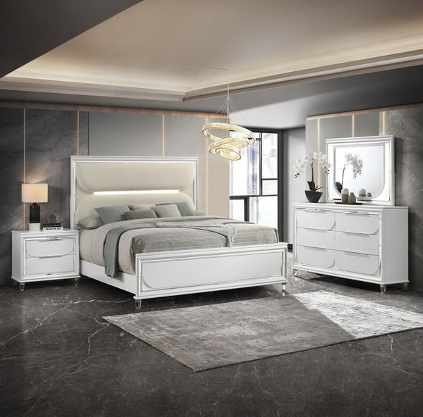 This bedroom set is a sophisticated fusion of modern design and luxurious comfort. Each piece boasts a bright white finish, accented with sleek mirrored trim that adds a touch of shine and refinement. The centerpiece is an opulent bed with an oversized he