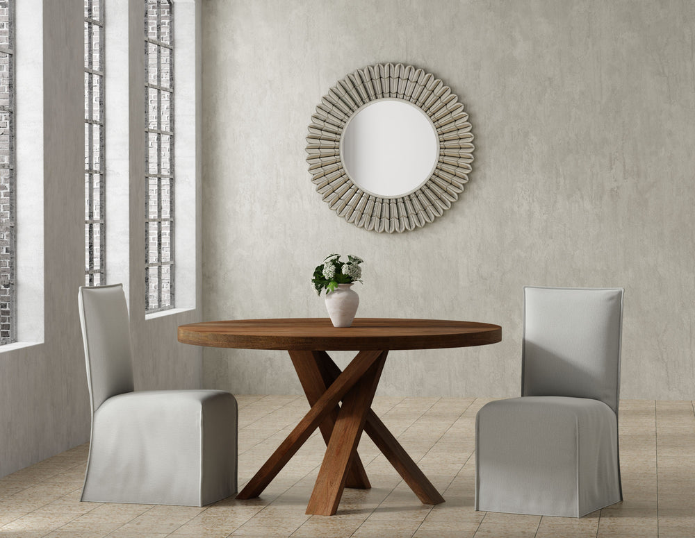 Bring a touch of global-inspired elegance to your dining room with the 60 Inch Round Dining Table. This handcrafted table is made from solid mango, giving it a unique aesthetic with natural variations of color, wood grain, and knots. The round table is pa