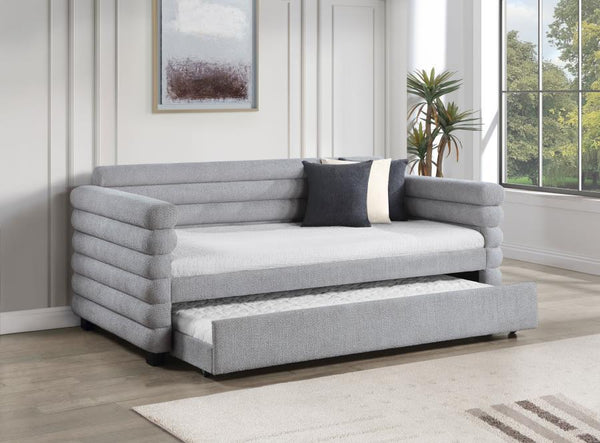  the daybed is designed with layered round bolsters