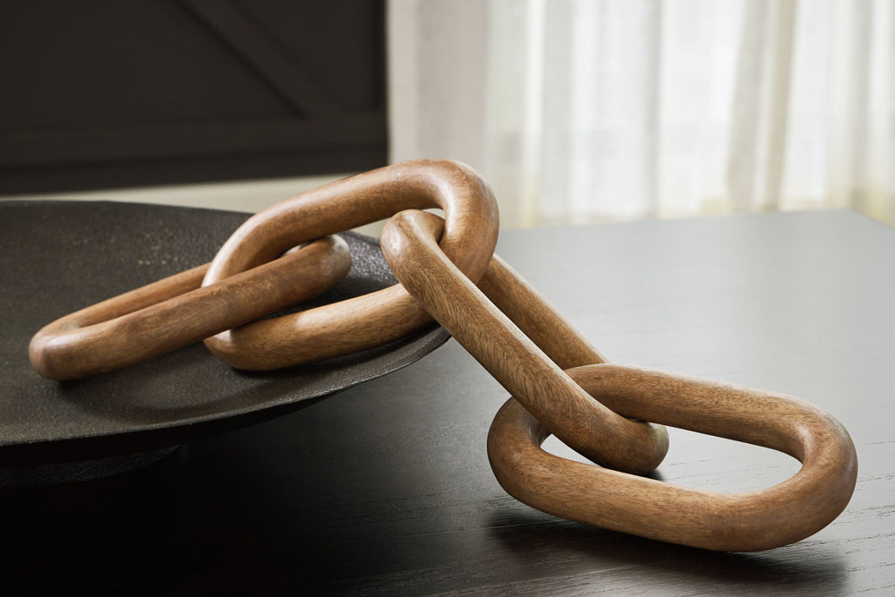 This sculpture sets the standard for casually cool art. Interlocking wood rings in a natural brown finish add an organic element to your decor. When displayed on a TV stand or fireplace mantel, or draped across a stack of books, it-'s such an impressive f