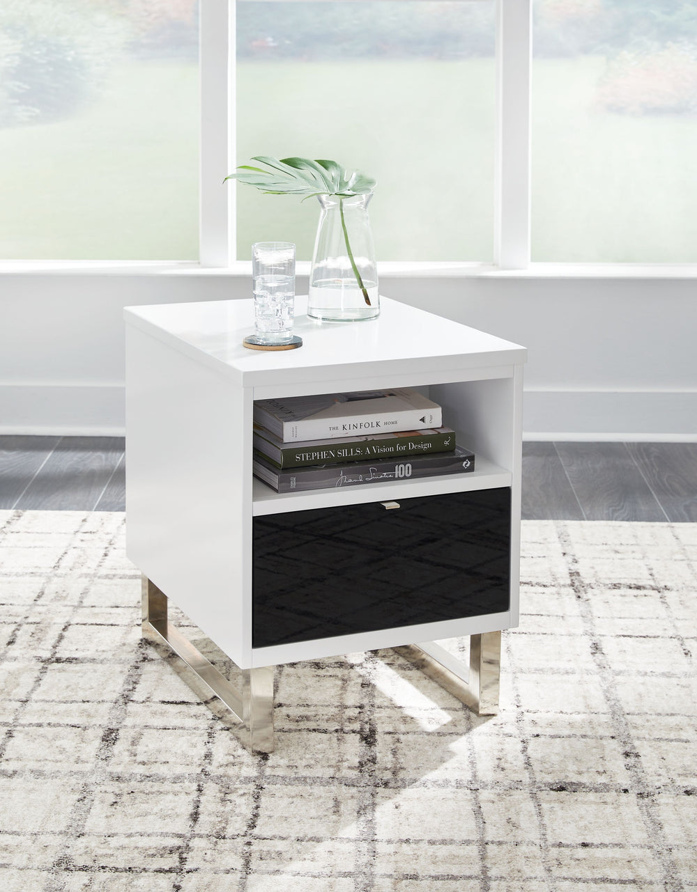 Combining a high-gloss white finish with a black drawer front, this chairside end table proves opposites really do attract. It-'s the perfect blend of modern style and functionality, with plenty of space for essentials and convenient USB charging. What a 