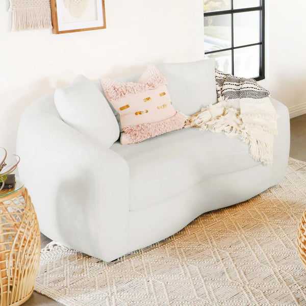  featuring boucle upholstery that presents an inviting cloud-inspired resting place. Gracefully curved armrests