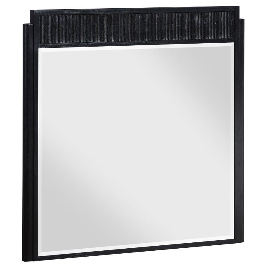 Complete your dresser with a stylish framed mirror. A perfect complement, it features a wooden frame complete with a fluted panel on top that adds rich depth and dimension. The mirror features a black finish with wire brushing that creates textural flair.